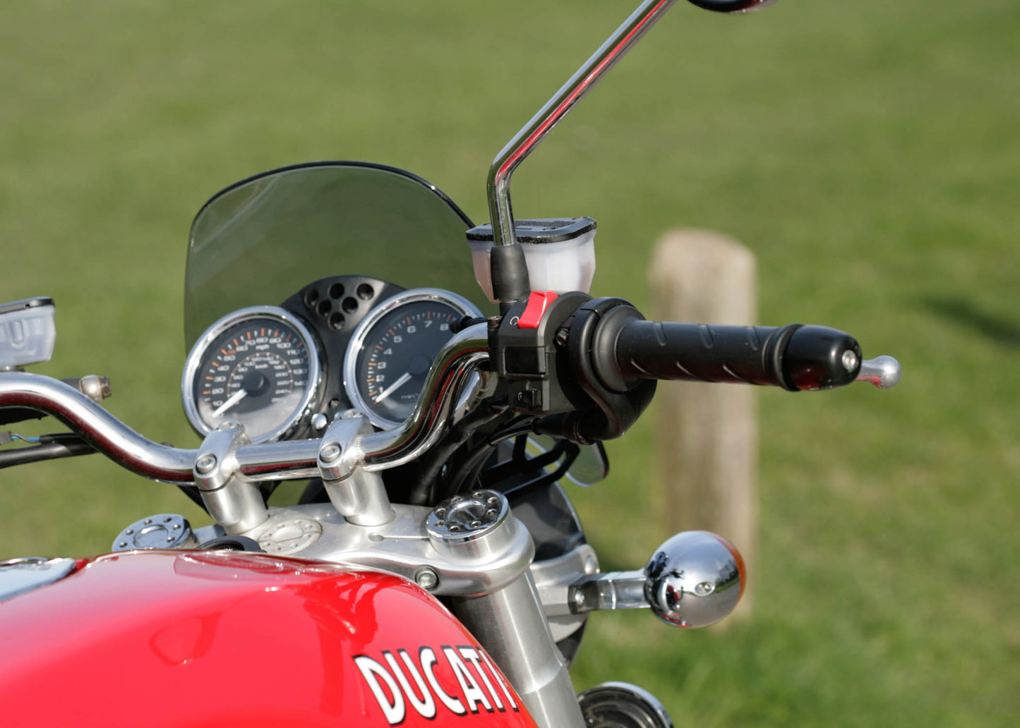 Close of dashboard of a Ducati Sport Classic in red with a clear tinted Dart Flyscreen